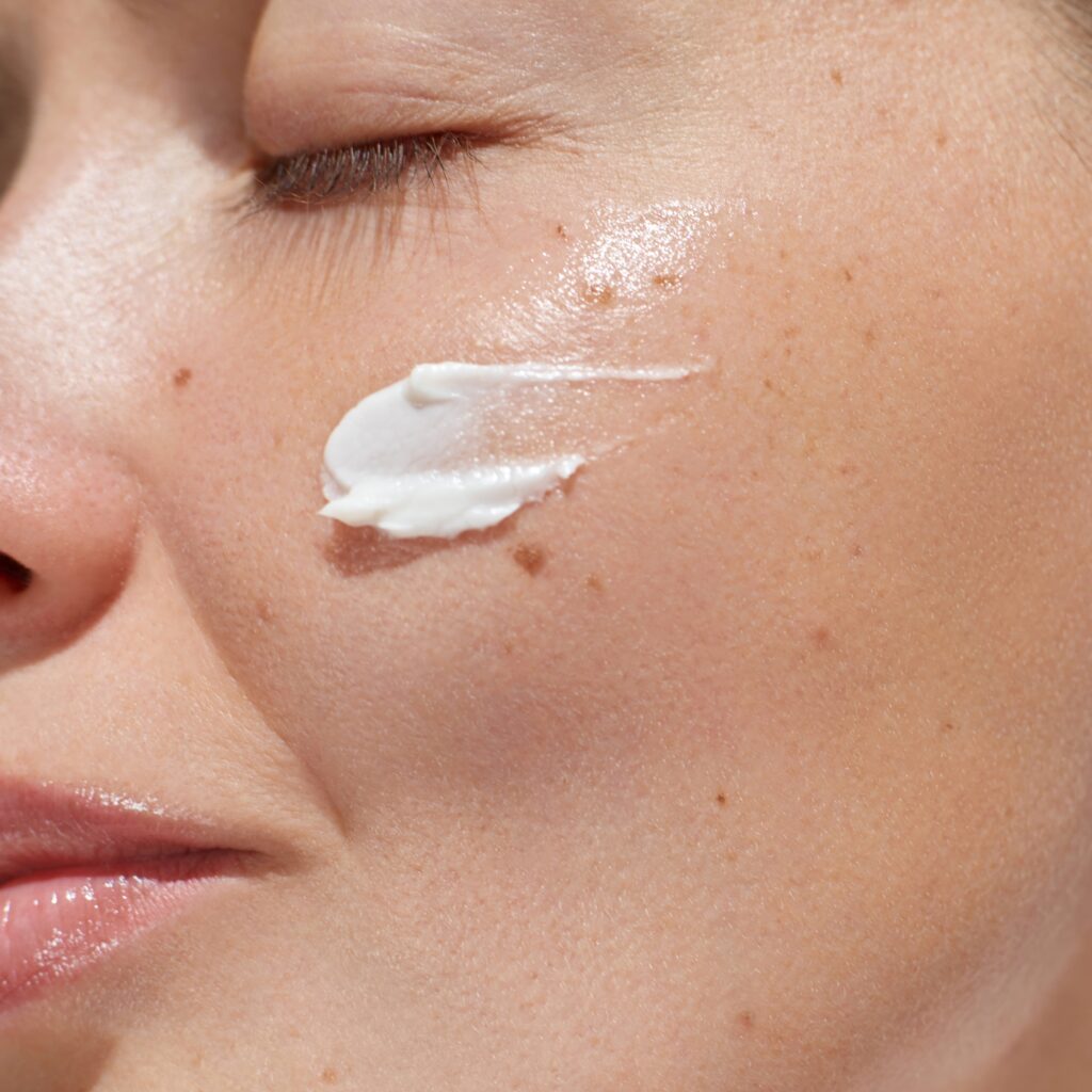 cream,smear.,beauty,close,up,portrait,of,young,woman,with